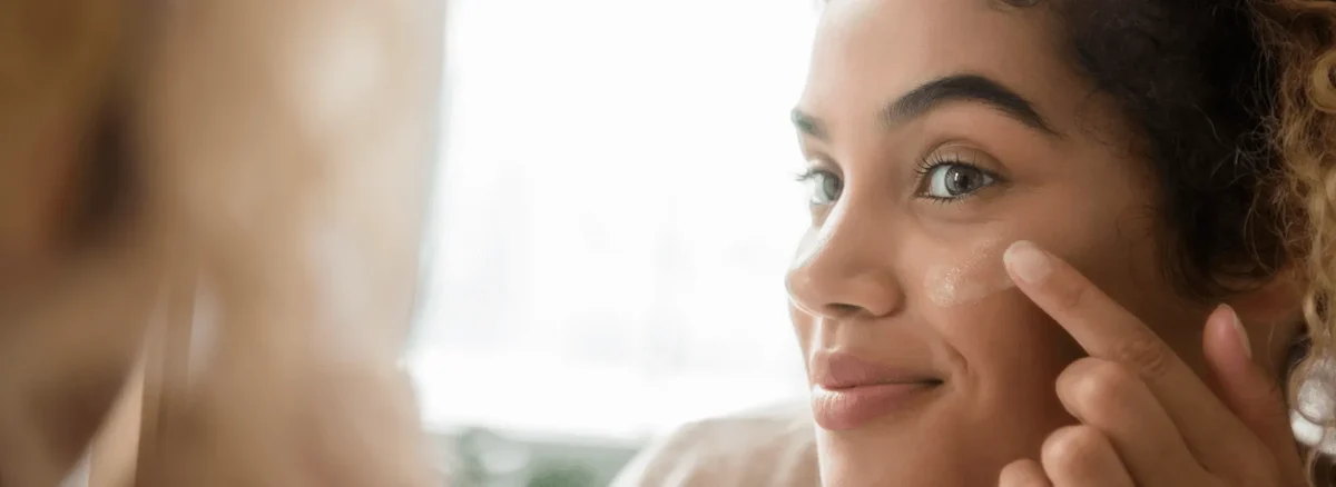woman applies face cream