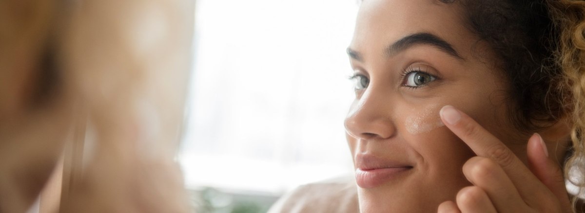Girl applying lotions on face image