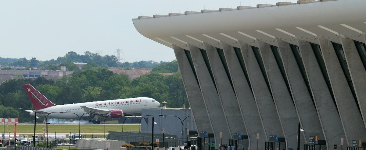 DULLES, VIRGINIA - MAY 12: An Omni Air International charter flight from South Africa to the United States lands at Washington Dulles International Airport on May 12, 2025 in Dulles, Virginia. Several dozen white South Africans, also called Afrikaners, accepted an invitation from the Trump Administration to come to the United States as refugees. They say they are fleeing job discrimination and racial violence in their home country. Trump has halted virtually all refugee admissions for people fleeing famine and war, but has created an expedited path into the U.S. for Afrikaners, descendants of