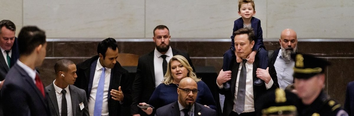 WASHINGTON, DC - DECEMBER 5: Tesla CEO Elon Musk (center right), Co-Chair of the newly announced Department of Government Efficiency (DOGE) carries his son "X" on his shoulders and businessman Vivek Ramaswamy (center left), Co-Chair of the newly announced