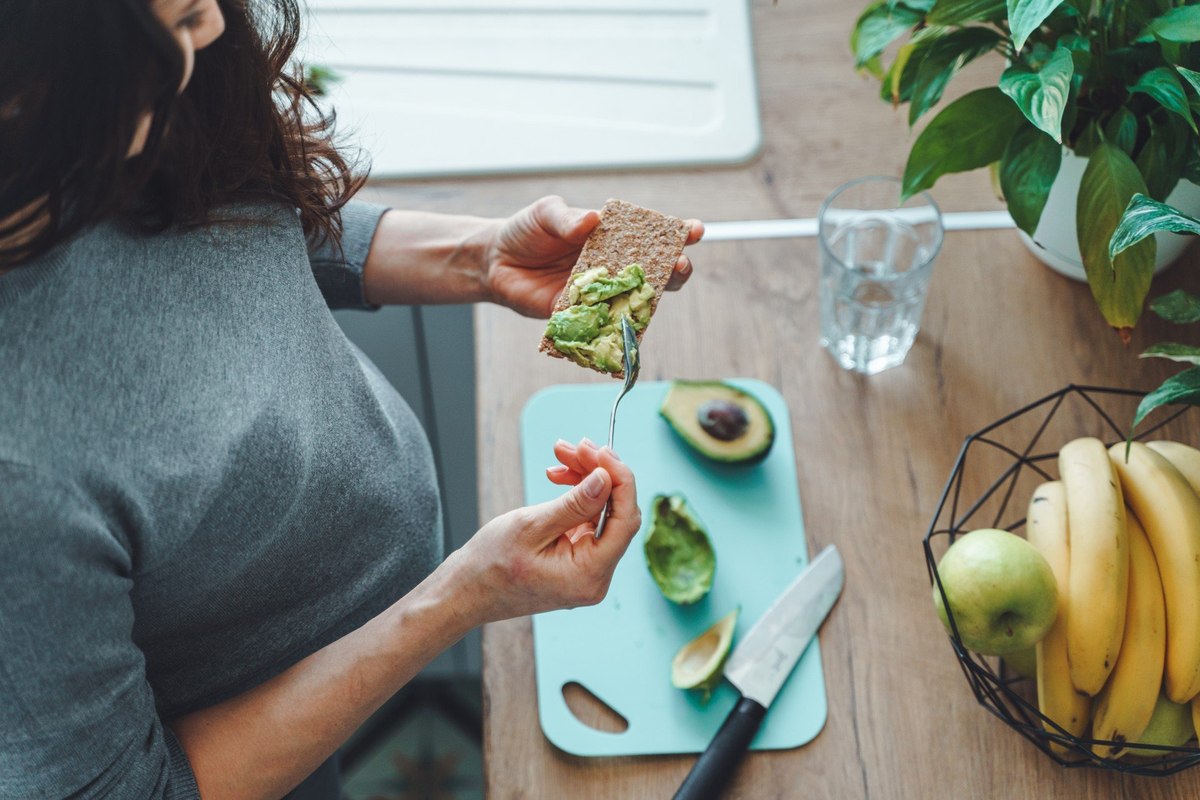 Woman preparing avocado toast