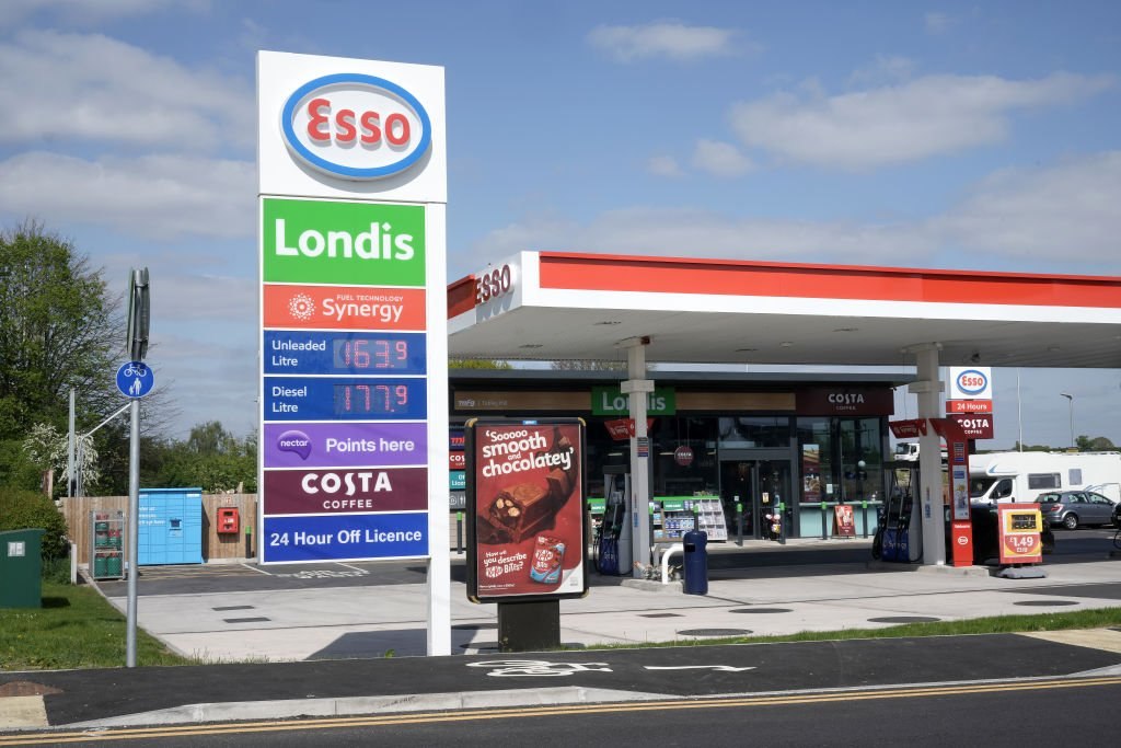 Once Britons have filled up their cars, what do they do at petrol stations?