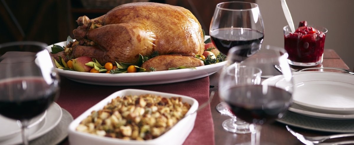 Turkey, stuffing, and cranberry dishes on table.