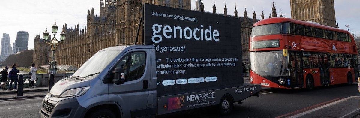 LONDON, ENGLAND - JANUARY 11: A Digital Ad Van with a definition of Genocide on, drives over Westminster Bridge on January 11, 2024 in London, England. The action was organised by a newly-formed London-based Palestinian support group