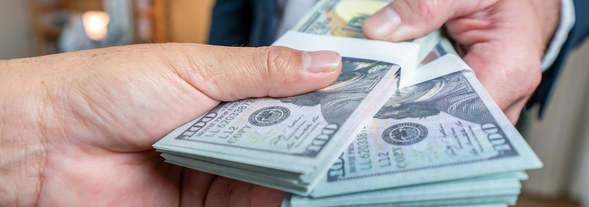 Hand giving money - United States Dollars