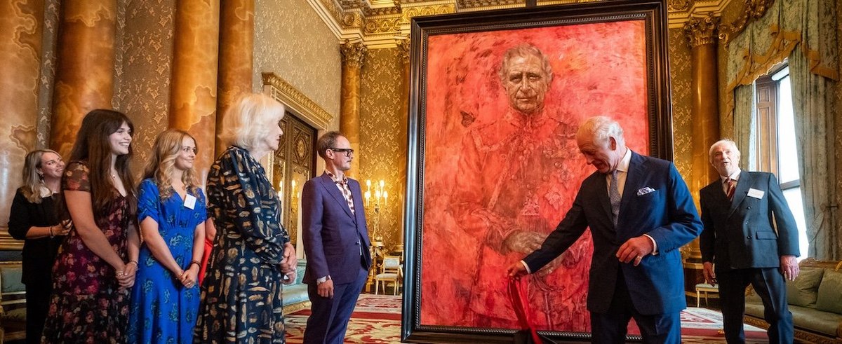 Queen Camilla, Artist Jonathan Yeo (5th L) and his family watch as King Charles III unveils his portrait by artist Jonathan Yeo in the blue drawing room at Buckingham Palace on May 14, 2024 in London, England.