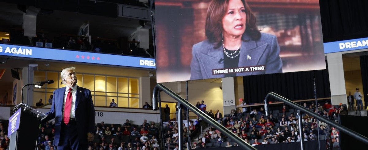 Republican presidential nominee, former President Donald Trump looks toward a video clip of Democratic presidential nominee U.S. Vice President Kamala Harris at a campaign rally at The PPL Center on October 29, 2024 in Allentown, Pennsylvania.