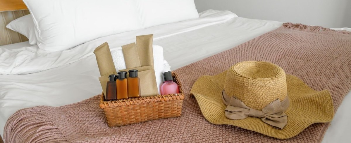 Cleaning body set and hat beach on bedroom in hotel.