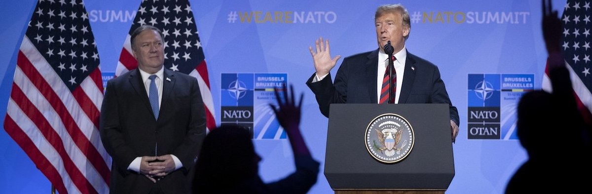 U.S. President Donald Trump gestures besides U.S. Secretary of State Mike Pompeo during a news conference at the 2018 NATO Summit at NATO headquarters on July 12, 2018 in Brussels, Belgium.
