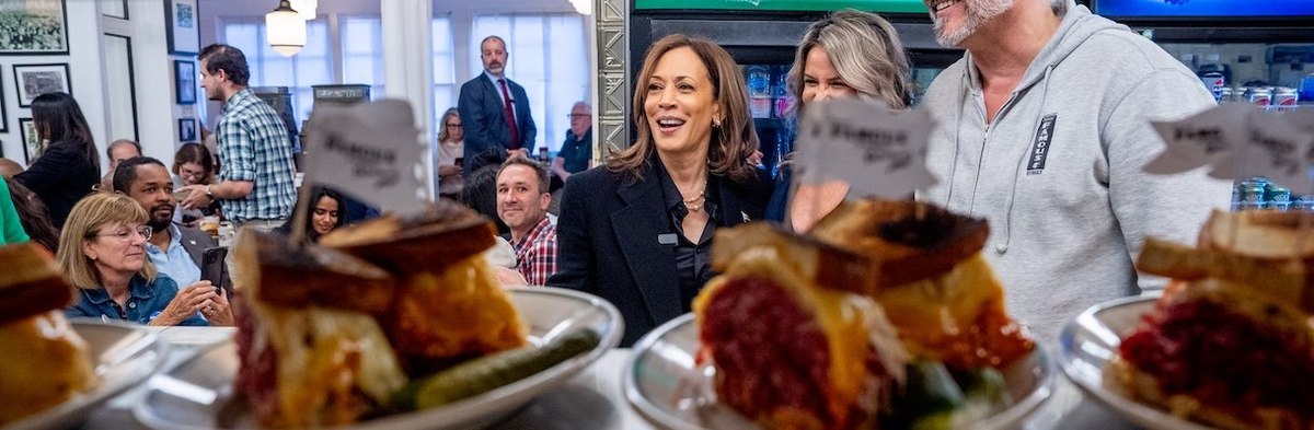 PHILADELPHIA, PENNSYLVANIA - OCTOBER 23: Plates of food are visible as Democratic presidential nominee, Vice President Kamala Harris greets supporters while visiting Famous 4th Street Delicatessen on October 23, 2024 in Philadelphia, Pennsylvania. With le