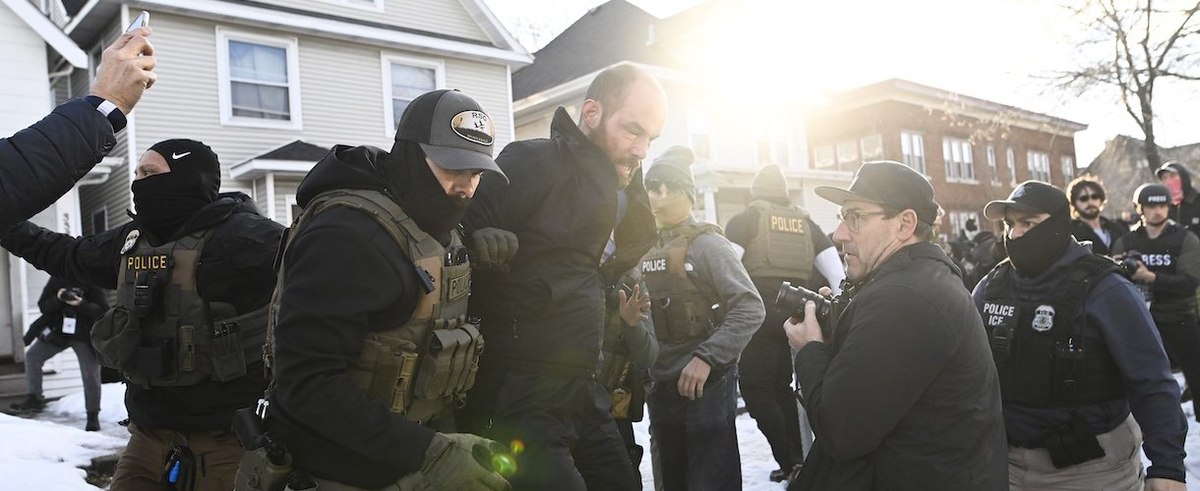 MINNEAPOLIS, MINNESOTA - JANUARY 13: An observer is detained by ICE agents after they arrested two people from a residence on January 13, 2026 in Minneapolis, Minnesota. The Trump administration has deployed over 2,400 Department of Homeland Security agents to the state of Minnesota in a push to apprehend undocumented immigrants. (Photo by Stephen Maturen/Getty Images)