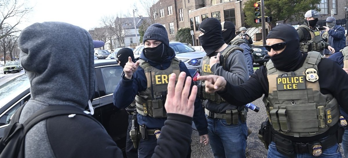 MINNEAPOLIS, MINNESOTA - JANUARY 13: ICE agents confront an observer on January 13, 2026 in Minneapolis, Minnesota. The Trump administration has deployed over 2,400 Department of Homeland Security agents to the state of Minnesota in a push to apprehend undocumented immigrants. (Photo by Stephen Maturen/Getty Images)