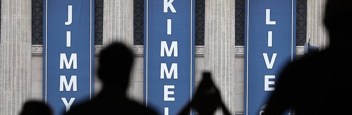 LOS ANGELES, CALIFORNIA - SEPTEMBER 18: People gather outside the El Capitan Entertainment Centre where the "Jimmy Kimmel Live!" show is performed in Hollywood on September 18, 2025 in Los Angeles, California. Kimmel's ABC late-night show has been "indefi