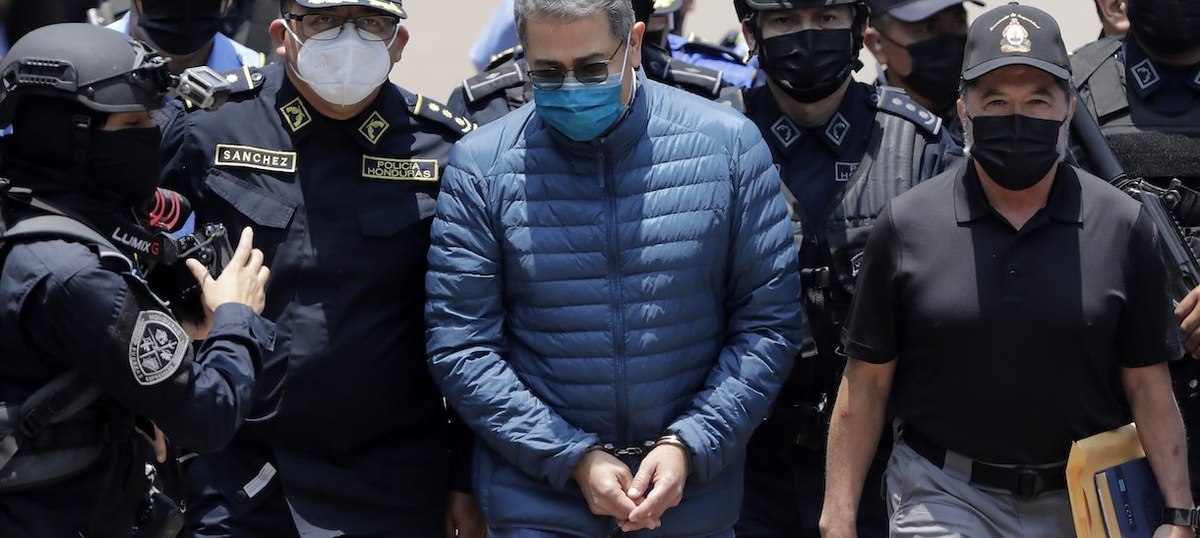 TEGUCIGALPA, HONDURAS - APRIL 21: Former President of Honduras Juan Orlando Hernandez is escorted by Members of the Police Special Forces to be extradited to U.S.to face charges of taking bribes from drug traffickers at Honduran National Directorate of Sp