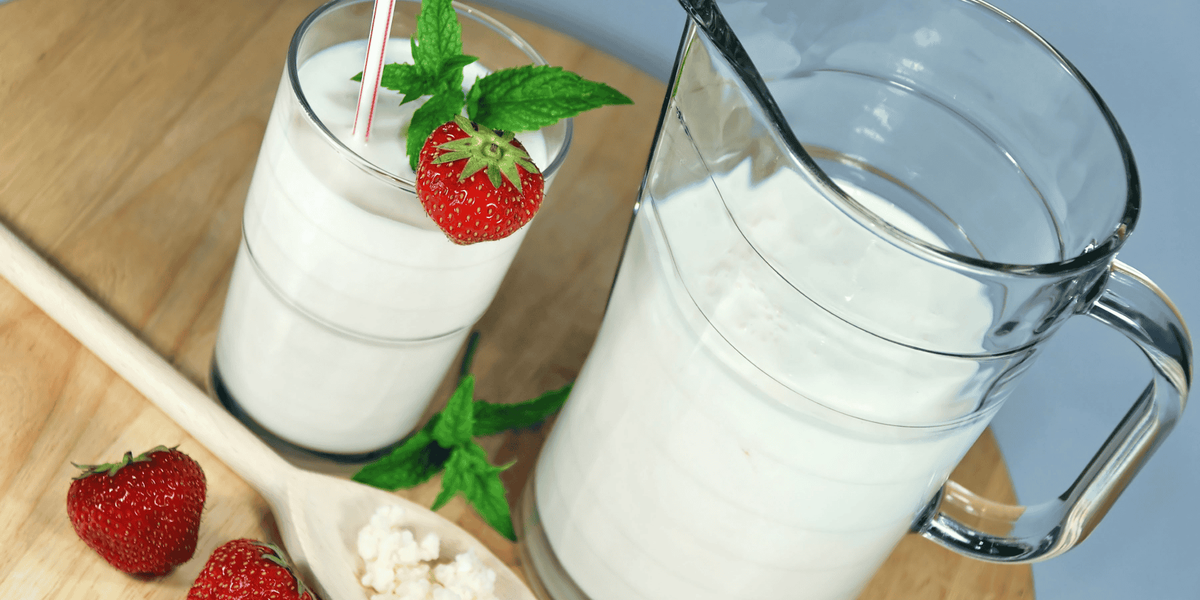 Glass and jar with yogurt