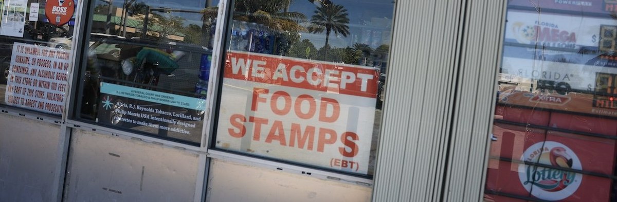 MIAMI, FLORIDA - OCTOBER 31: A 'We Accept Food Stamps' sign hangs in the window of a grocery store on October 31, 2025 in Miami, Florida. The food stamp program, now known as the Supplemental Nutrition Assistance Program (SNAP), may run out of funding on