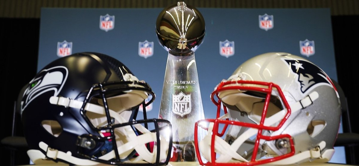 SAN JOSE, CALIFORNIA - FEBRUARY 02:The Vince Lombardi Trophy is framed by the Seattle Seahawks and New England Patriots helmets during Super Bowl LX Opening Night at San Jose McEnery Convention Center on February 02, 2026 in San Jose, California. (Photo by Chris Graythen/Getty Images)