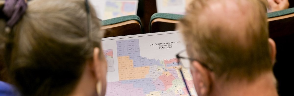AUSTIN, TEXAS - AUGUST 07: Attendees view a map during a Senate Special Committee on Congressional Redistricting public testimony hearing on August 07, 2025 in Austin, Texas. The Senate Special Committee on Congressional Redistricting met to hear public t