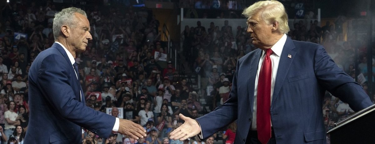 GLENDALE, ARIZONA - AUGUST 23: Former Republican presidential candidate Robert F. Kennedy Jr. and Republican presidential nominee, former U.S. President Donald Trump shake hands during a campaign rally at Desert Diamond Arena on August 23, 2024 in Glendal