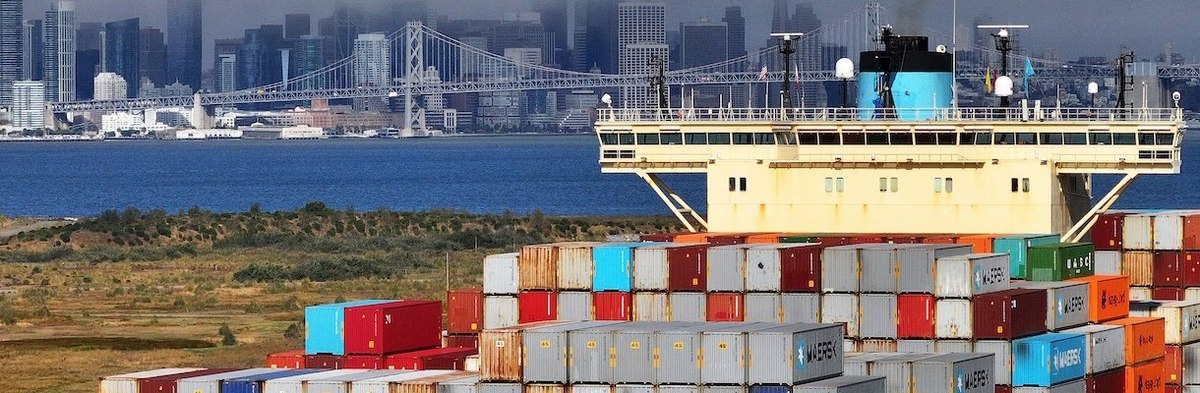 OAKLAND, CALIFORNIA - AUGUST 01: In an aerial view, a container ship arrives at the Port of Oakland on August 01, 2025 in Oakland, California. U.S. President Donald Trump announced that his August 1 deadline for trade deals will not be extended and sweepi