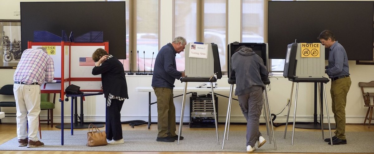 ASHEVILLE, NORTH CAROLINA - NOVEMBER 5: Voters are lined up at voting booths at Biltmore Forest Town Hall on November 5, 2024 in Asheville, North Carolina. Americans cast their ballots today in the presidential race between Republican nominee former President Donald Trump and Democratic nominee Vice President Kamala Harris, as well as multiple state elections that will determine the balance of power in Congress. (Photo by Melissa Sue Gerrits/Getty Images)