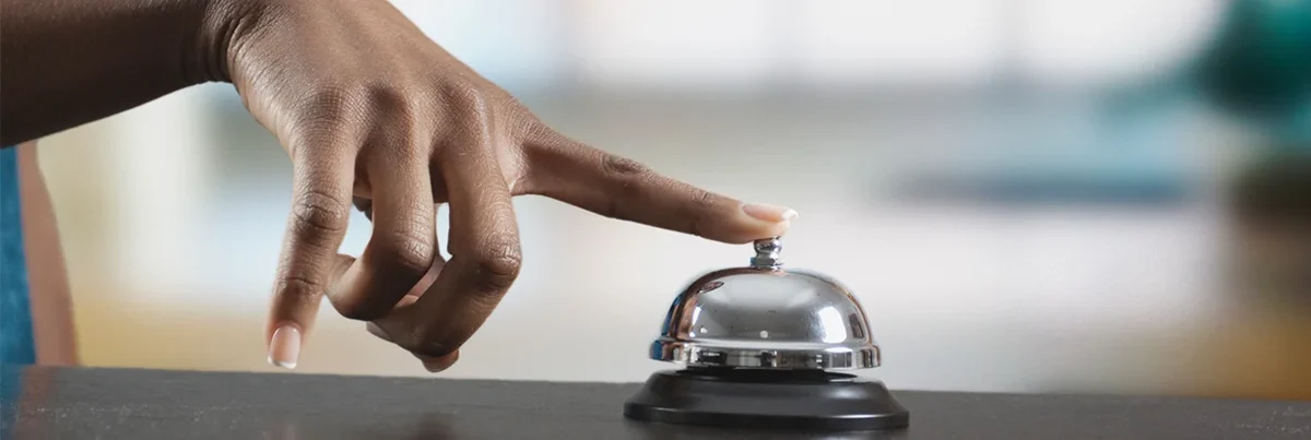 person ringing hotel bell